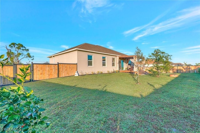 rear view of house with a yard