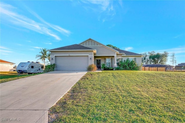 view of front of home with a garage and a front lawn