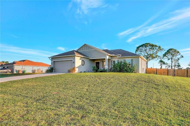 ranch-style home featuring a garage and a front yard