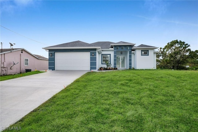 view of front of home featuring a front yard and a garage