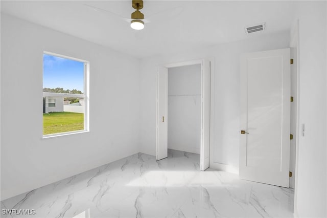 unfurnished bedroom featuring ceiling fan and a closet