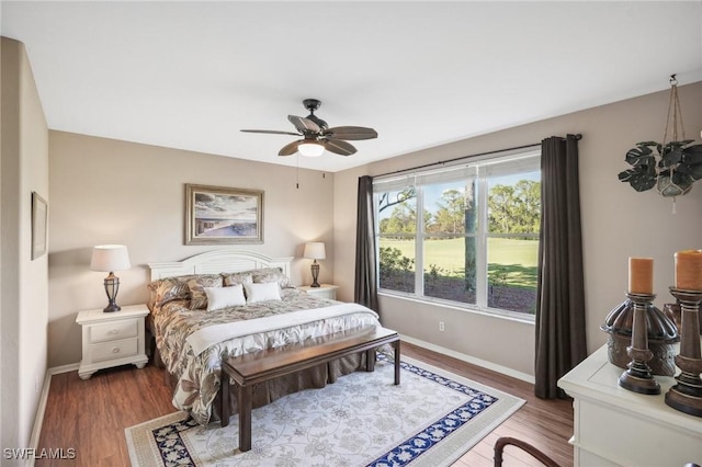 bedroom featuring ceiling fan and dark hardwood / wood-style flooring