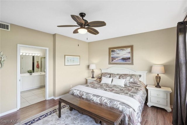 bedroom featuring ensuite bathroom, ceiling fan, and light hardwood / wood-style floors