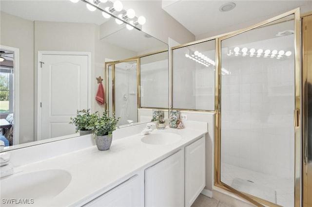 bathroom featuring walk in shower and vanity