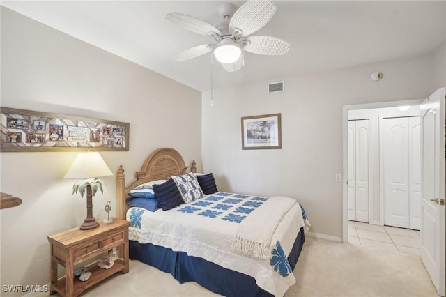 bedroom featuring a closet, ceiling fan, and light tile patterned flooring