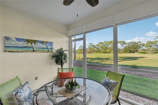 sunroom featuring ceiling fan