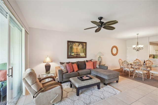 living room with ceiling fan with notable chandelier and light tile patterned floors