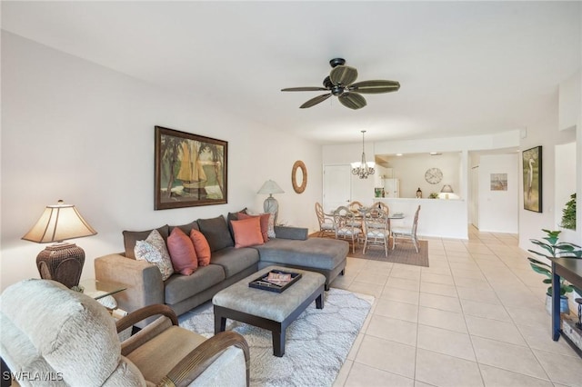 tiled living room featuring ceiling fan with notable chandelier