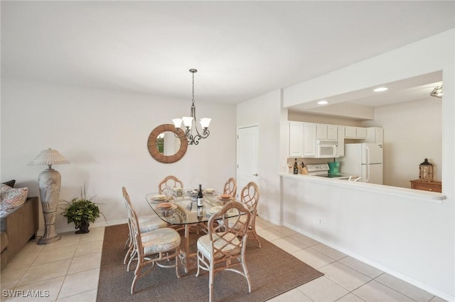 dining space featuring light tile patterned floors and a notable chandelier