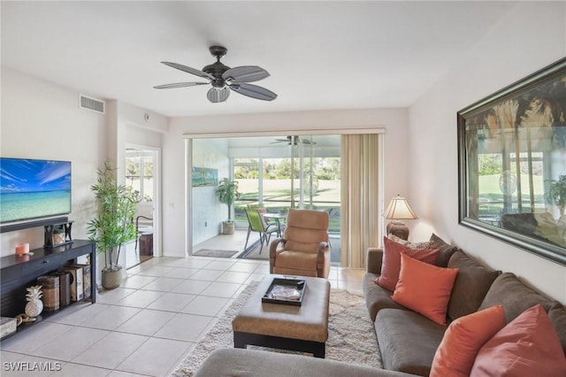 tiled living room featuring ceiling fan