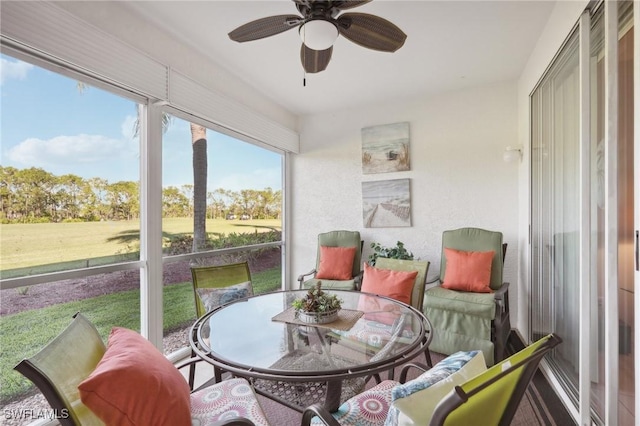 sunroom featuring ceiling fan