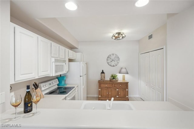 kitchen featuring white cabinetry, sink, and white appliances