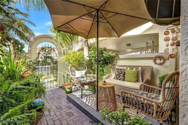 view of patio with an outdoor hangout area and a gate