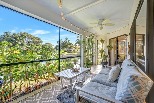 sunroom / solarium with a water view and ceiling fan