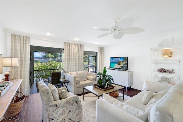 living room featuring ceiling fan and dark hardwood / wood-style floors