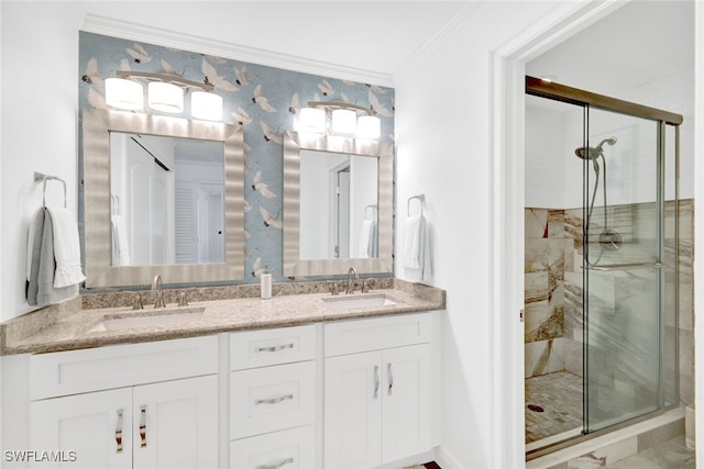 bathroom with crown molding, vanity, and an enclosed shower