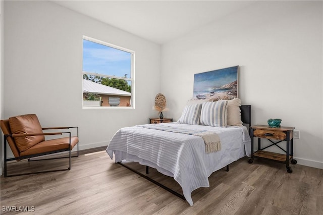 bedroom with hardwood / wood-style floors