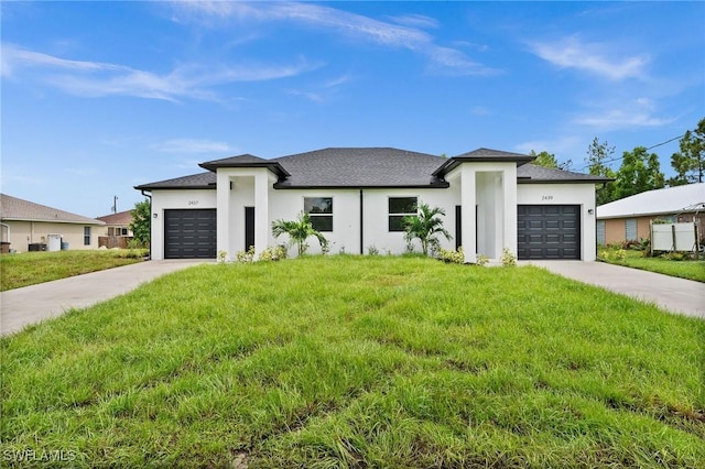 view of front of house with a front yard and a garage