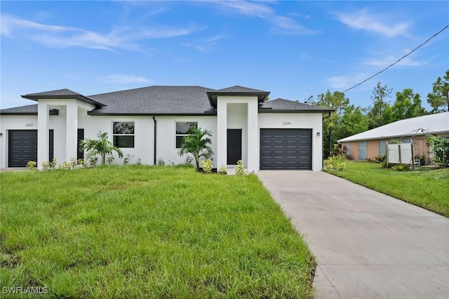 view of front of property with a garage and a front lawn