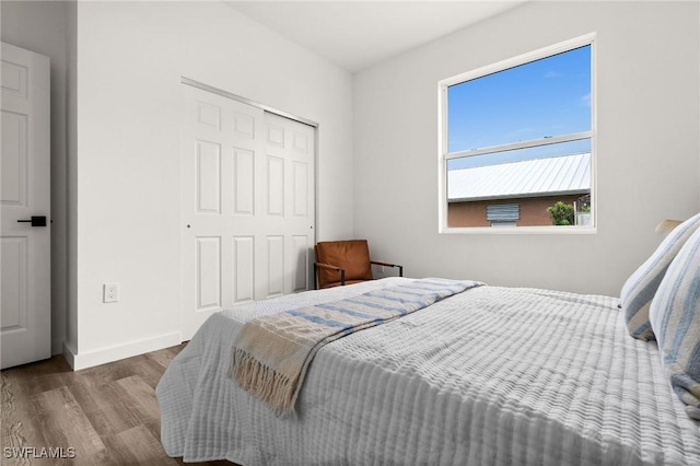 bedroom with hardwood / wood-style flooring and a closet