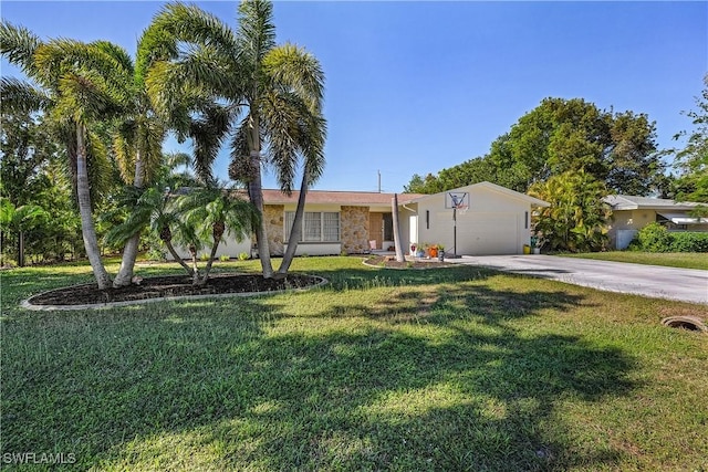 single story home with a garage and a front lawn