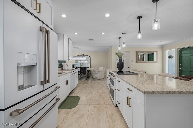 kitchen with white cabinetry, white appliances, and hanging light fixtures