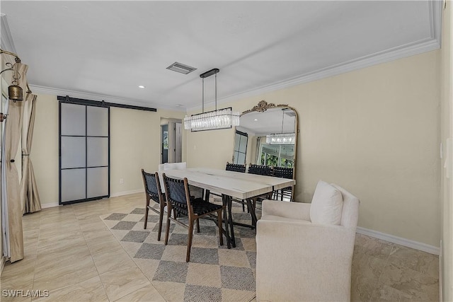 dining room featuring a barn door and ornamental molding