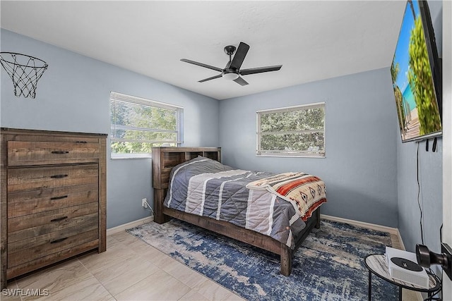 bedroom featuring multiple windows and ceiling fan