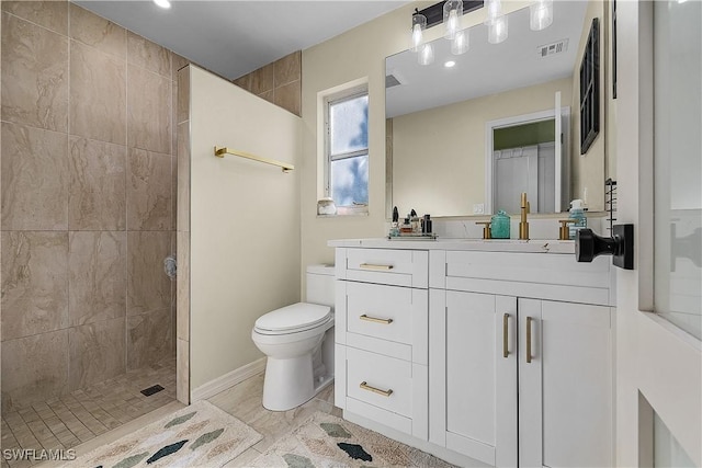 bathroom featuring vanity, toilet, wood-type flooring, and tiled shower