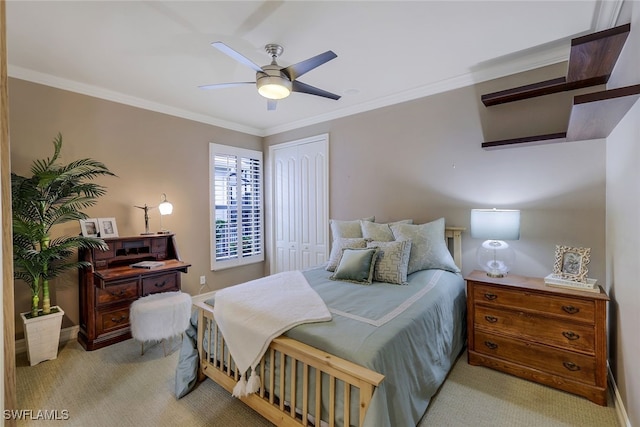 carpeted bedroom featuring ceiling fan, a closet, and ornamental molding