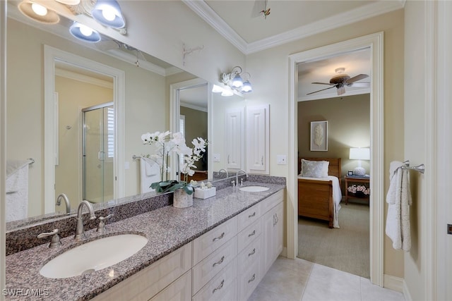 bathroom featuring tile patterned floors, vanity, crown molding, and an enclosed shower