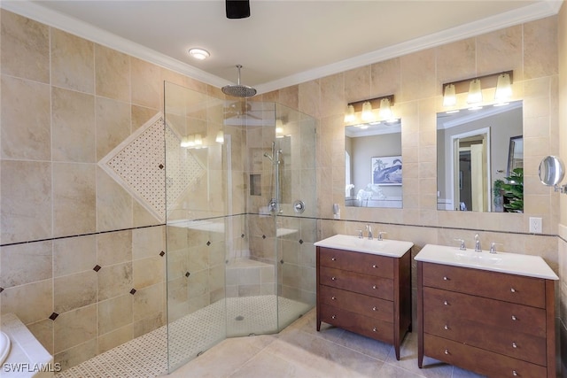 bathroom with crown molding, tile walls, a tile shower, tile patterned flooring, and vanity