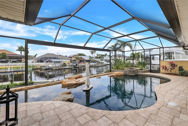 view of pool featuring glass enclosure, a patio area, an in ground hot tub, and a water view