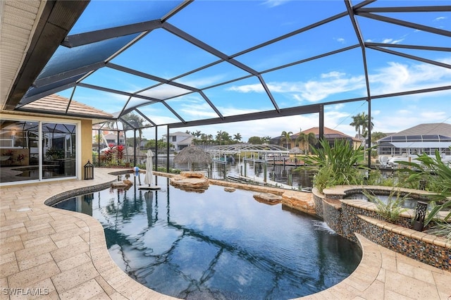 view of swimming pool with an in ground hot tub, glass enclosure, a patio area, and a water view