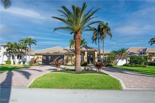 view of front of home featuring a garage and a front yard