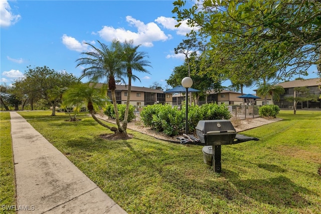 view of property's community with a yard
