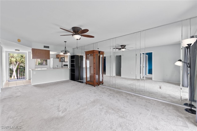 unfurnished living room featuring light carpet