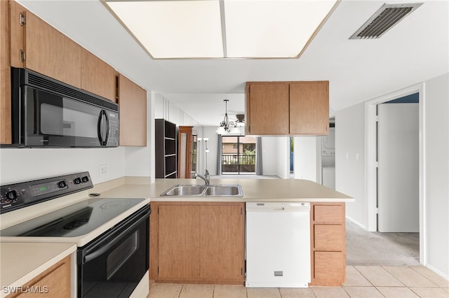 kitchen featuring kitchen peninsula, electric range oven, white dishwasher, sink, and light tile patterned floors
