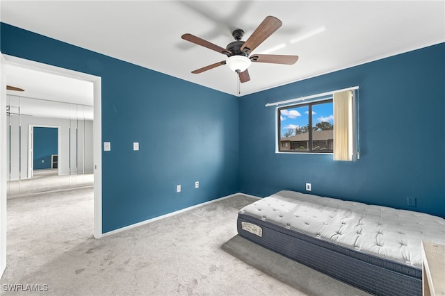 unfurnished bedroom featuring ceiling fan and carpet floors