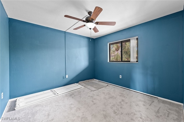 empty room with ceiling fan and carpet