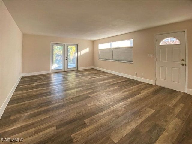 entrance foyer featuring dark hardwood / wood-style floors and french doors