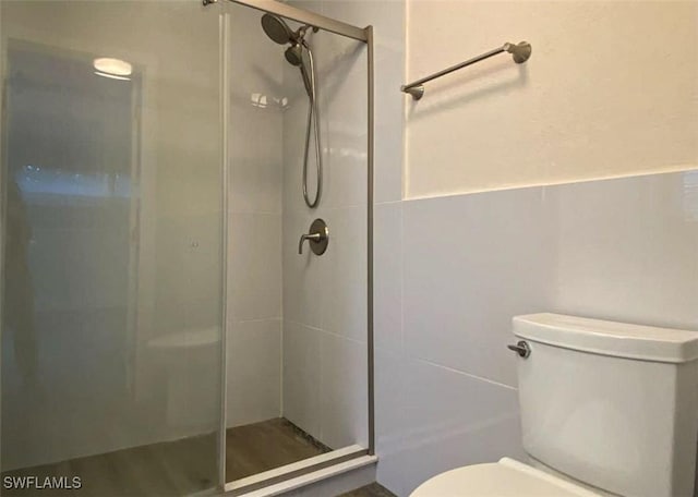 bathroom with an enclosed shower and toilet