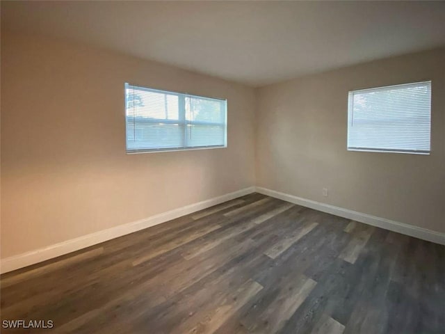 empty room with dark hardwood / wood-style floors