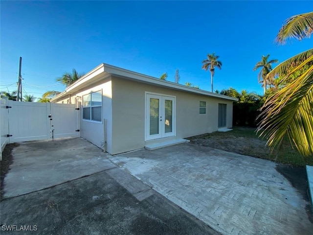 rear view of house featuring french doors and a patio