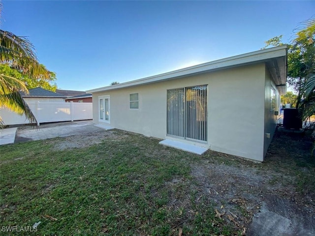 rear view of house with a yard