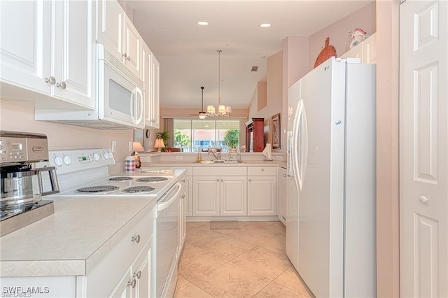 kitchen with kitchen peninsula, white appliances, white cabinetry, and a notable chandelier