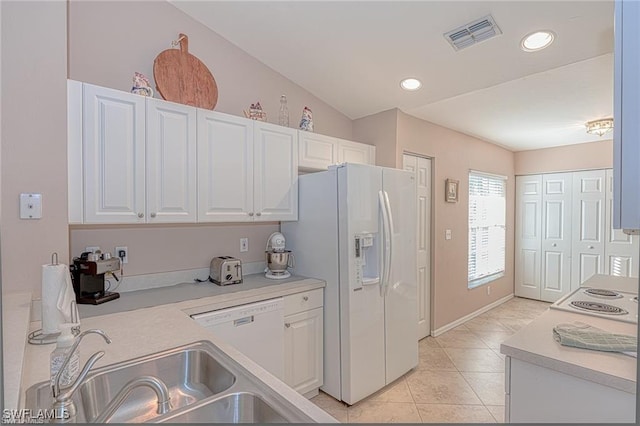 kitchen with white cabinetry, sink, white appliances, lofted ceiling, and light tile patterned floors