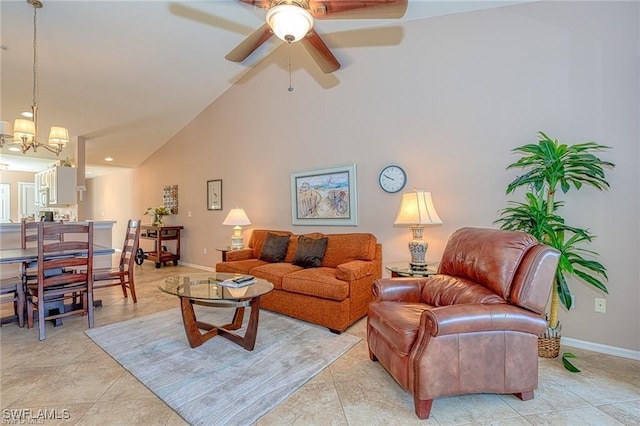 tiled living room with ceiling fan with notable chandelier and high vaulted ceiling