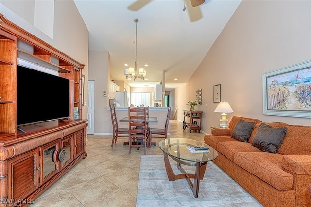 tiled living room with ceiling fan with notable chandelier and high vaulted ceiling