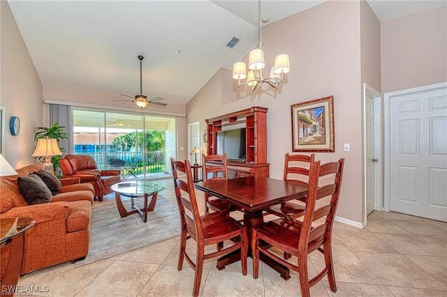 dining room with light tile patterned floors, high vaulted ceiling, and ceiling fan with notable chandelier